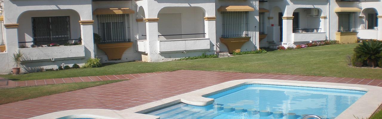 Our fine apartment on the ground floor of a small cosy complex with terrace right out to the greens and the pool area